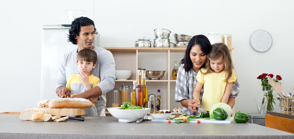 Portrait of a family preparing lunch in the kitchen