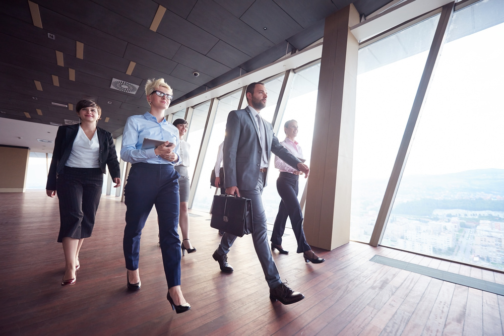 business team, businesspeople group walking at modern bright office interior business team, businesspeople group walking at modern bright office interior